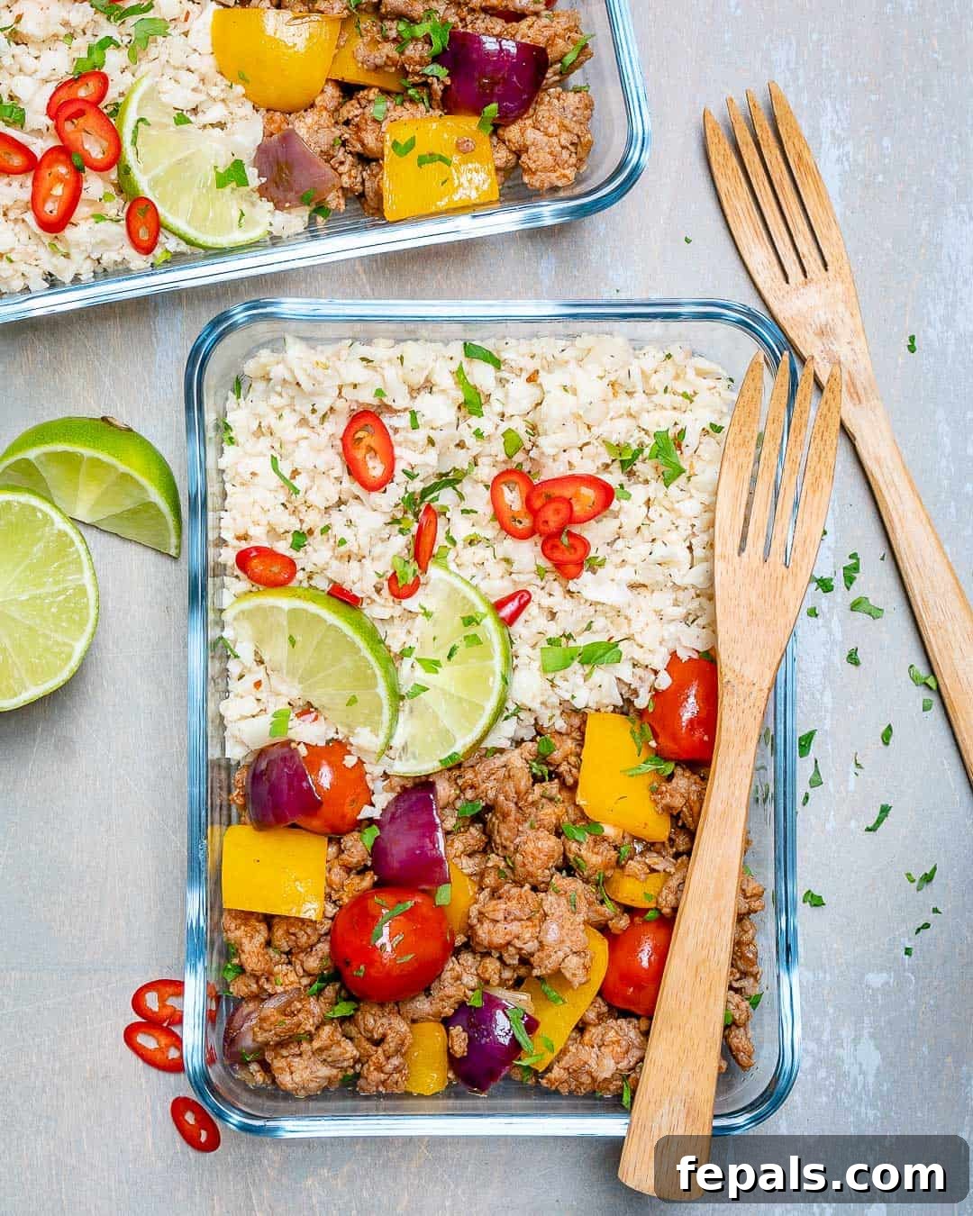 Ground Turkey and Cauliflower Rice Skillet Cauliflower rice and ground turkey in glass containers with veggies and forks, ready for healthy meal prep.