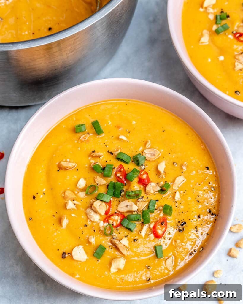 sweet potato soup recipe with peanuts on top in a round white bowl