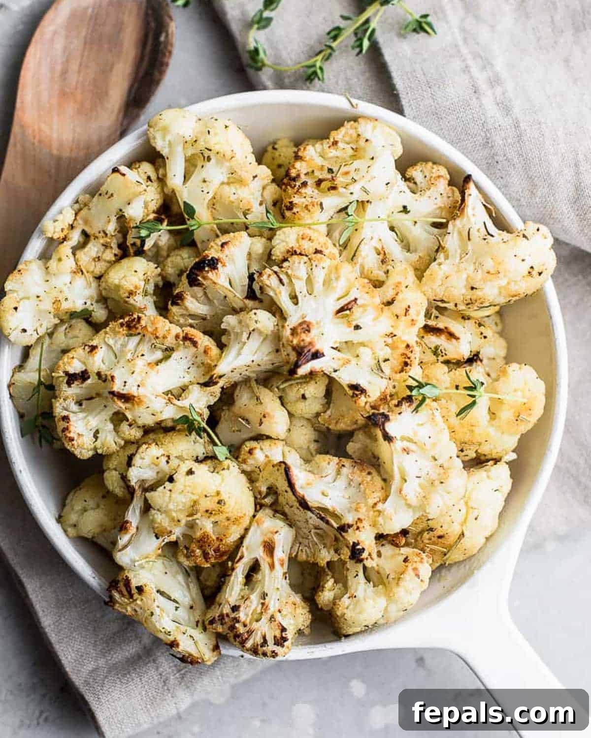 A tantalizing bowl of perfectly roasted garlic cauliflower, ready to be served as a wholesome side dish.