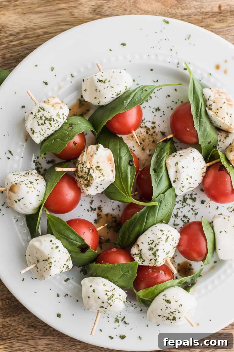 Top view of Caprese skewers artfully arranged on a white plate, ready to serve