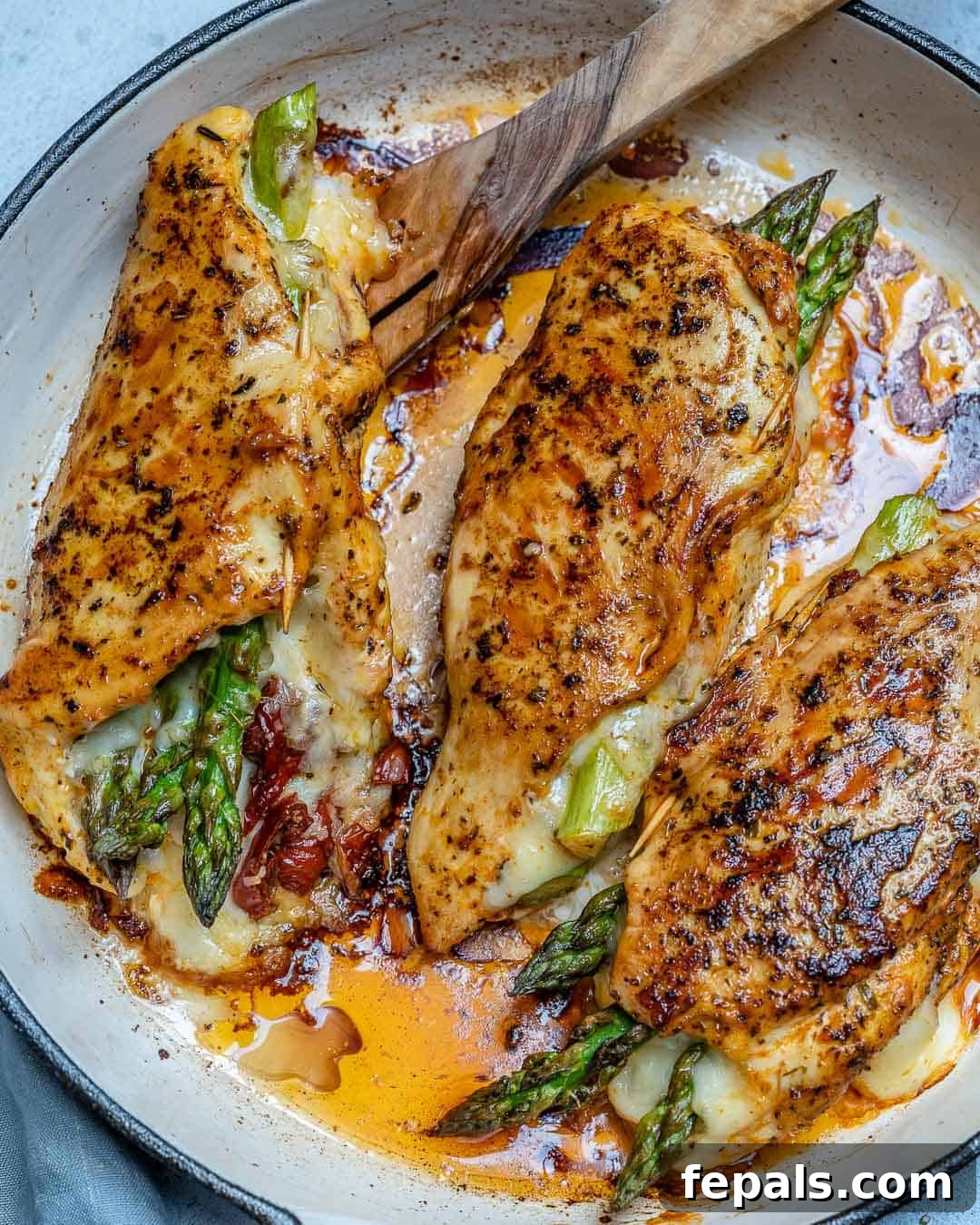picking up chicken with a wooden spoon