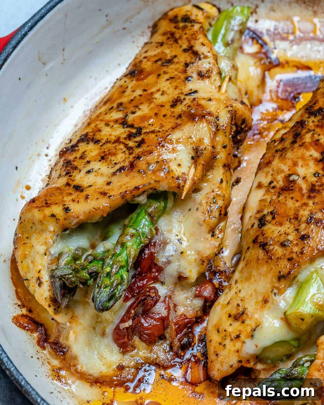 Stuffed chicken breast in a pan.