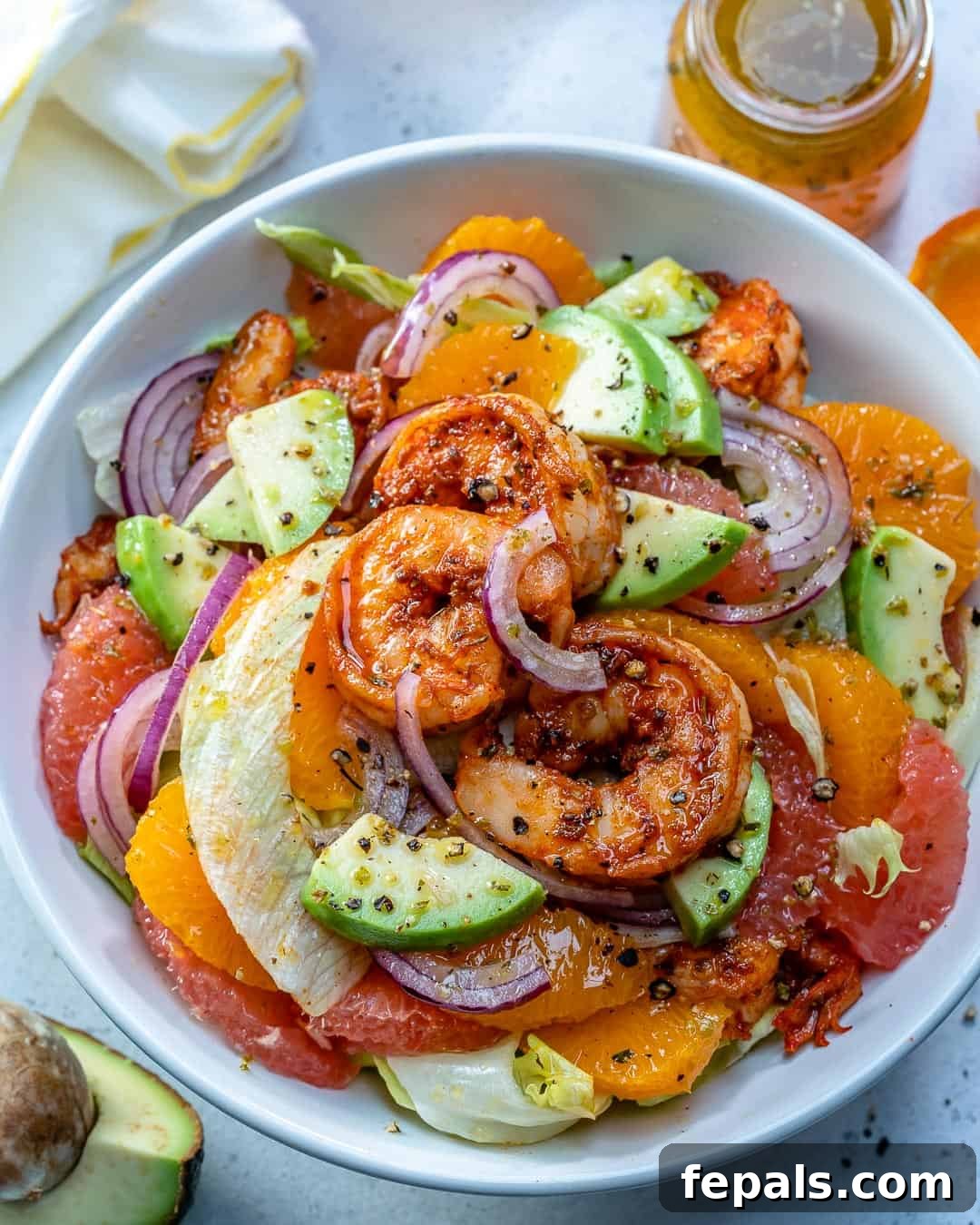 A vibrant Citrus Cajun Shrimp Salad featuring grapefruit, oranges, and creamy avocado, ready to be enjoyed in a bowl.