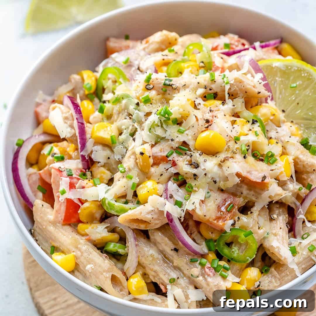 a round Mexican pasta salad topped with shredded cheese.