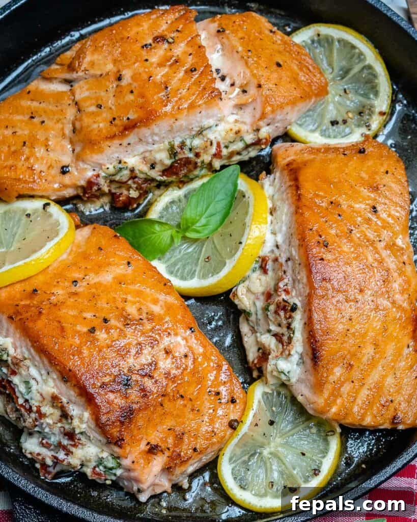 Top view of 3 stuffed salmon in a blackck skillet