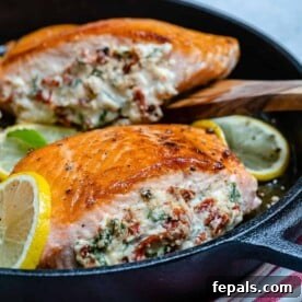 side shot of 2 stuffed salmon fillets with sun-dried tomatoes and cream cheese