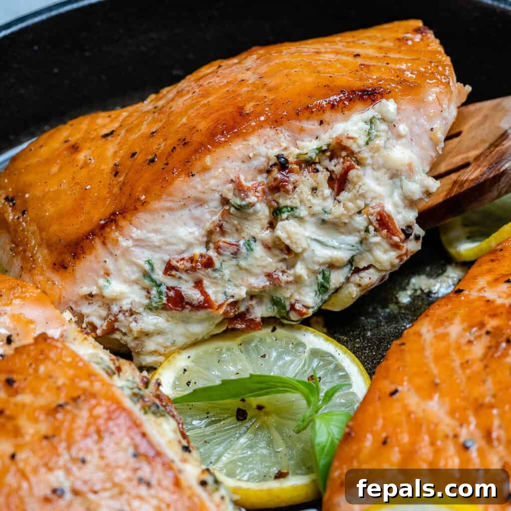 side shot of a single stuffed salmon in a black pan