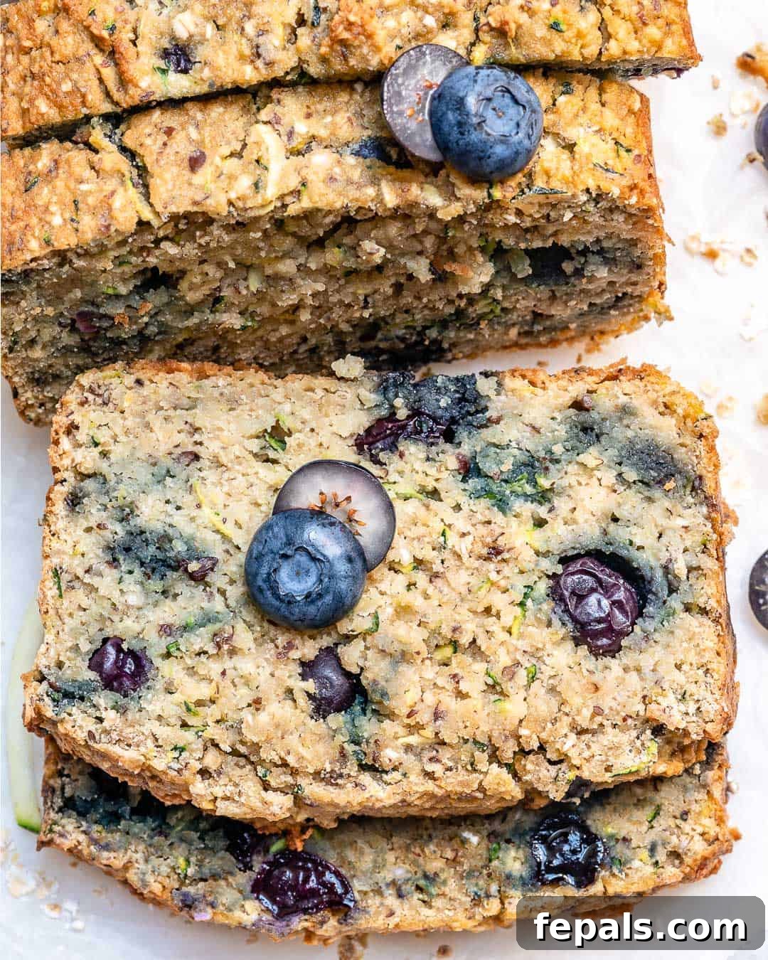 Delicious Blueberry Zucchini Bread 2 Two moist slices of Blueberry Zucchini Bread stacked, showcasing the vibrant blueberries and tender crumb.