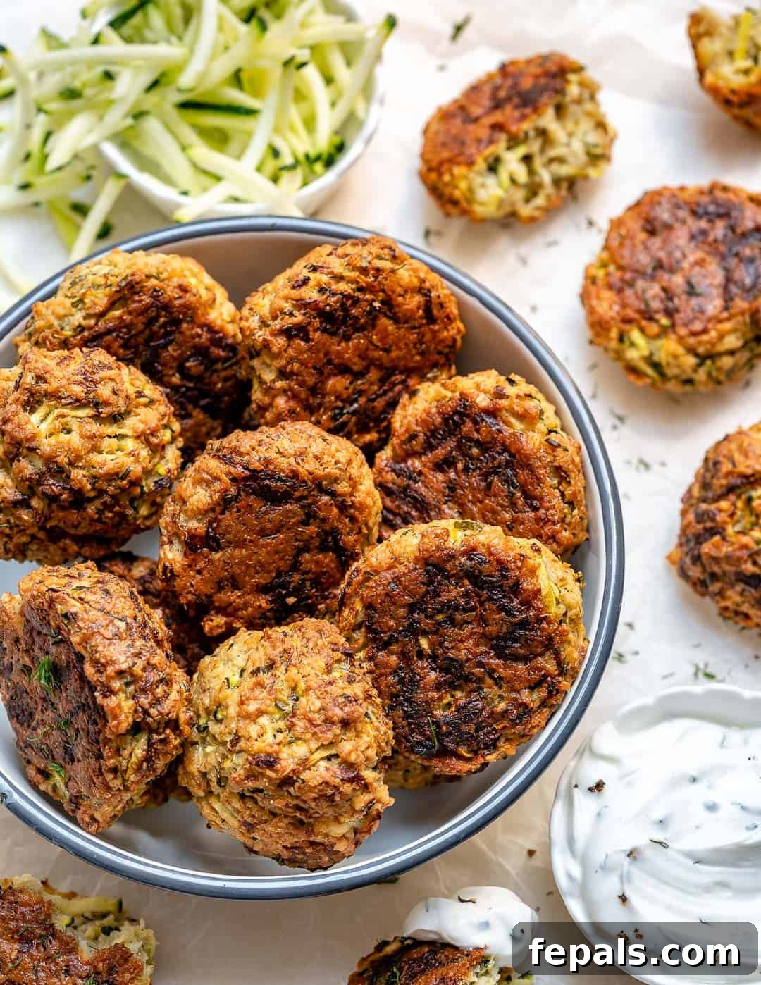 Savory Baked Garlic Herb Zucchini Fritters 2 Crispy Baked Garlic Herb Zucchini Fritters, perfect for a healthy snack or appetizer.