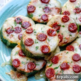 Zucchini Pizza Poppers 7 Zucchini pizza bites slices topped with melted cheese and mini pepperoni.