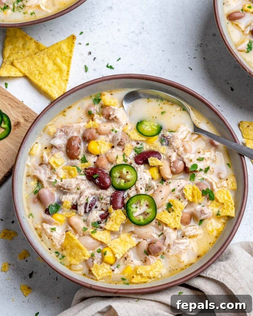 Creamy White Chicken Chili 3 bowl of white bean chill topped with sliced jalapenos