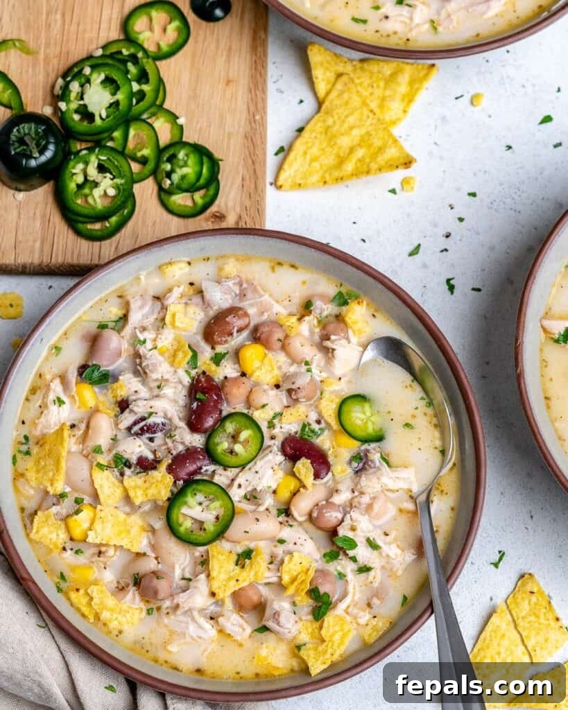 Creamy White Chicken Chili 6 top view of a bowl of white chicken chili with spoon in bowl