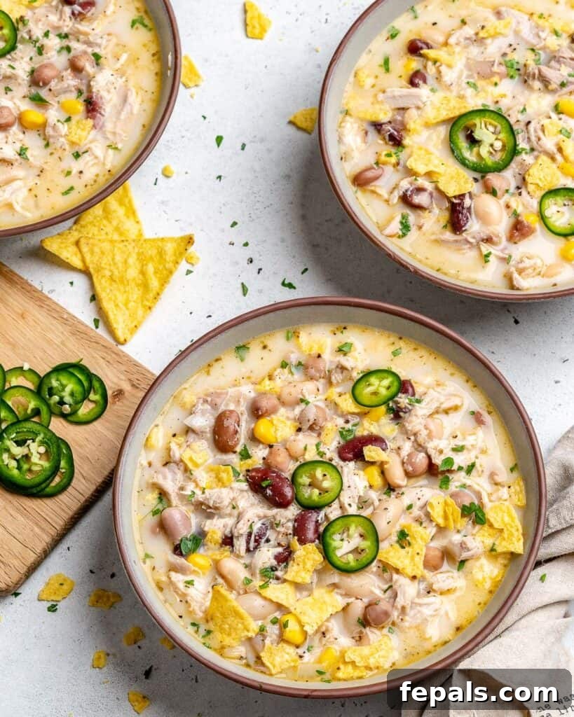 Creamy White Chicken Chili 7 top view of white chicken chili in a bowl with another bowl full of chili next to it