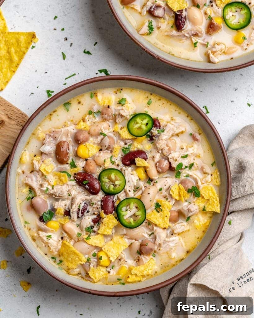 Creamy White Chicken Chili 8 white chicken chili recipe in a round bowl made with 4 different beans