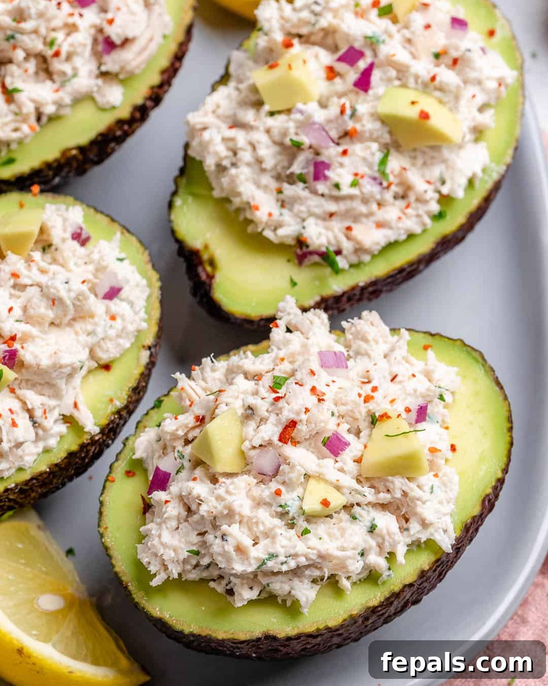 Wholesome Chicken Salad Avocado Boats 2 Easy and healthy chicken salad recipe stuffed in avocados, garnished with fresh parsley.