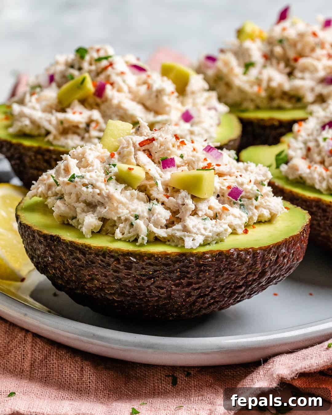 Wholesome Chicken Salad Avocado Boats 3 Easy chicken salad recipe with avocados, showing the vibrant mix before stuffing.
