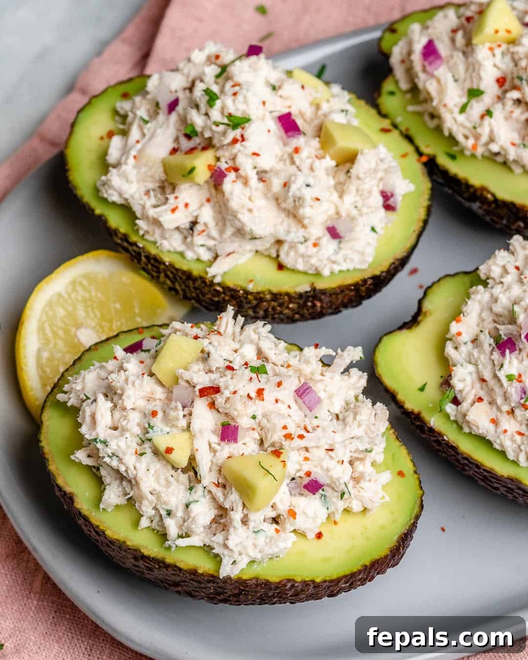 Wholesome Chicken Salad Avocado Boats 8 Side shot of stuffed avocados, showing the vibrant filling.