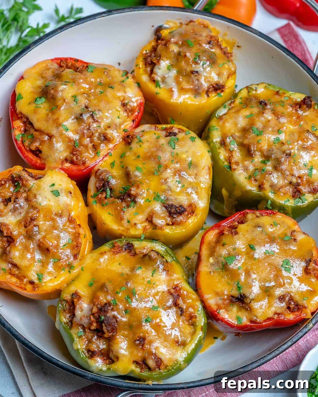 Healthy Stuffed Peppers with Rice and Ground Beef easy stuffed bell peppers on plate, garnished with fresh parsley