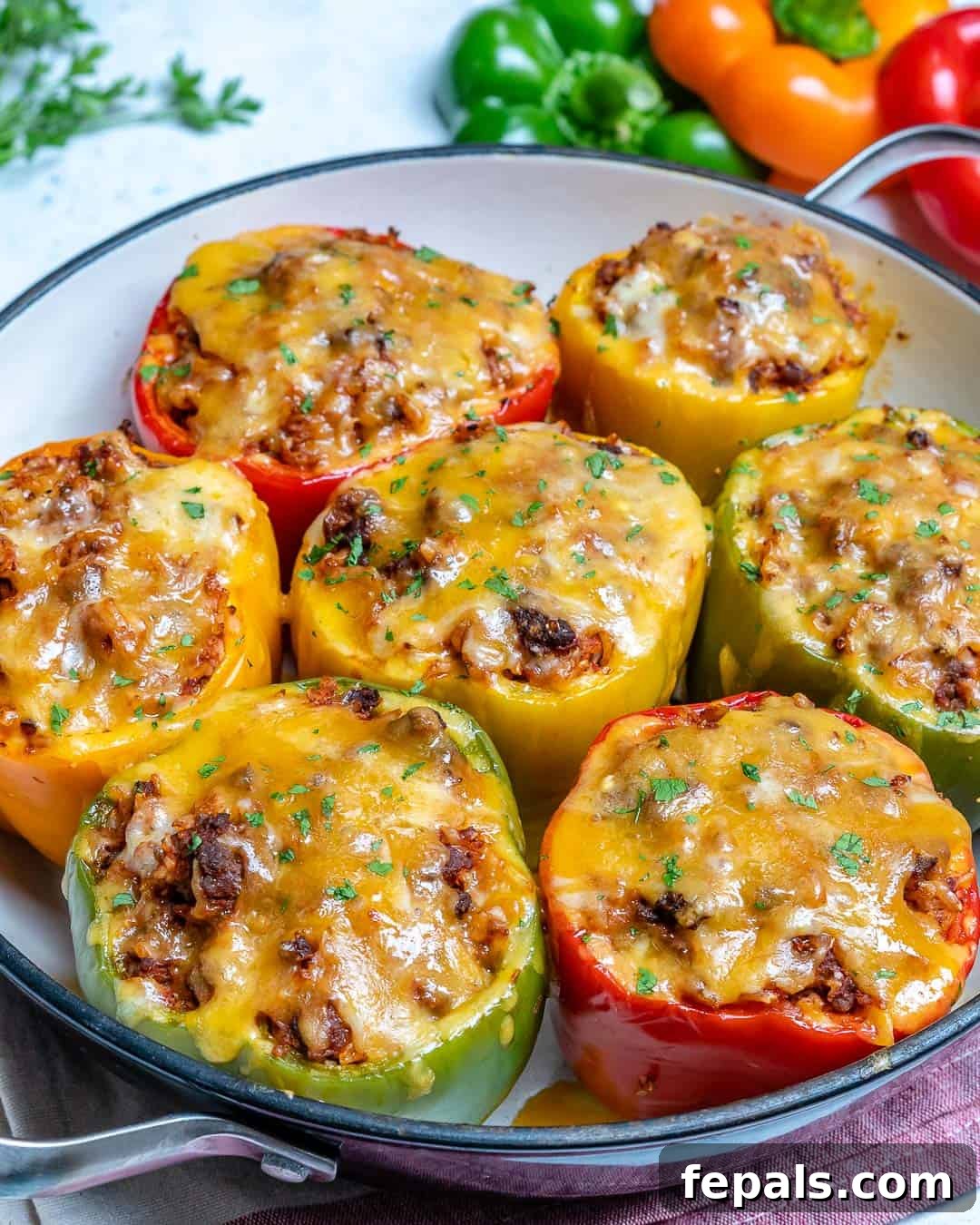 Easy Recipe for Stuffed Bell Peppers with Ground Beef and Rice bell peppers with ground beef in pan with cheese and parsley
