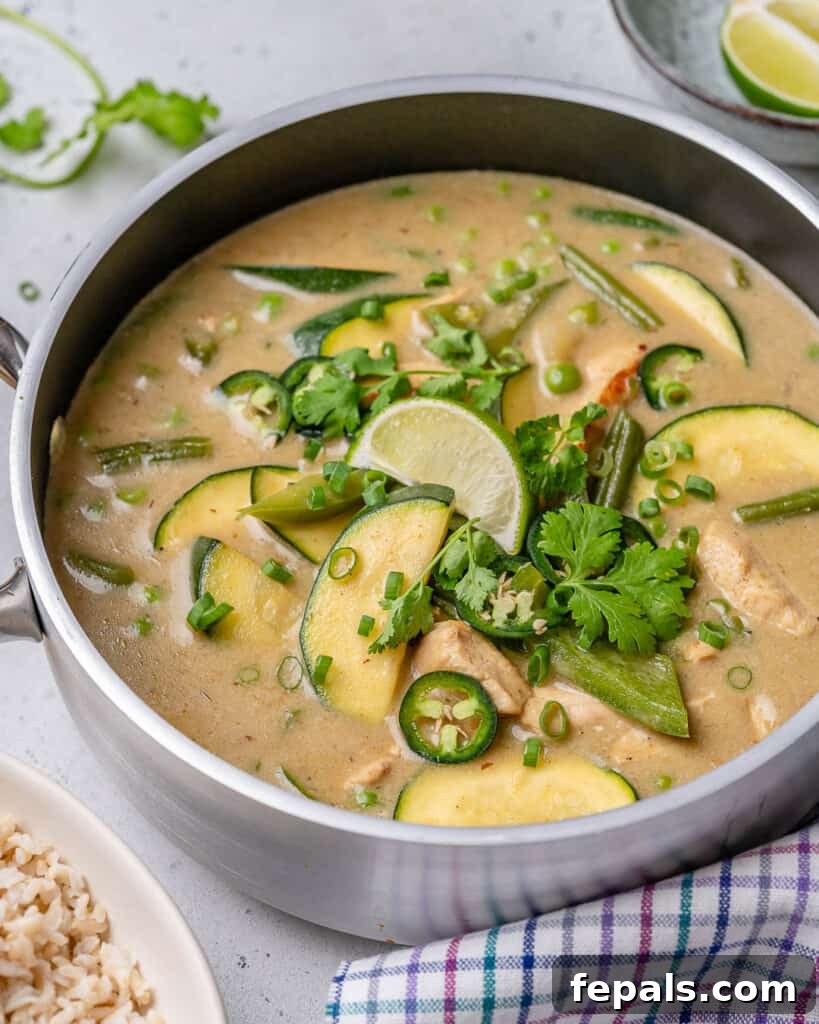 side shot of green chicken curry recipe in a cooking pan 