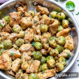 Creamy Chicken Alfredo with Roasted Brussels Sprouts 9 a pan with chicken alfredo and veggie in a creamy sauce.