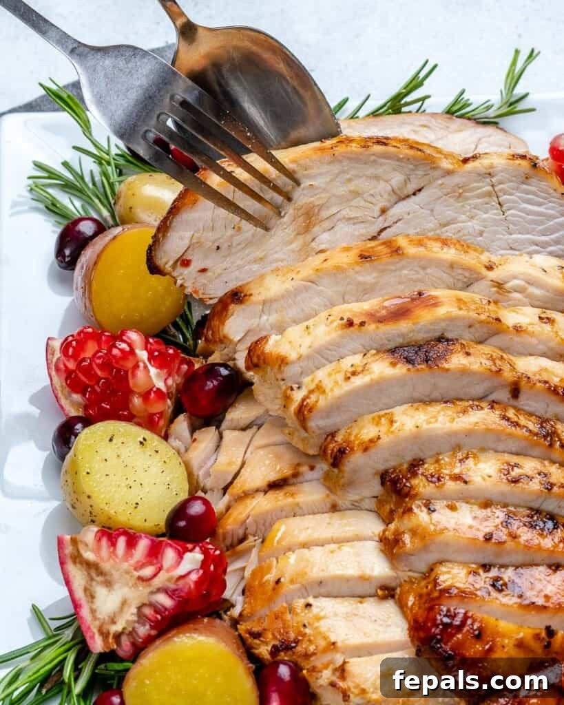 close up of baked turkey slices with hand and fork grabbing a slice