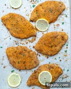 Golden Baked Chicken Cutlets 19 Baked chicken cutlets last on a sheet pan topped with lime slices and shopped parsley.