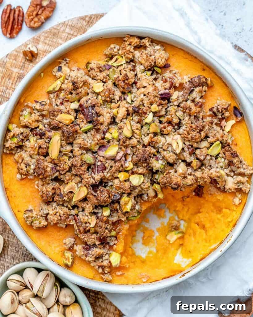 baked potato casserole in a round dish topped with an nut topping