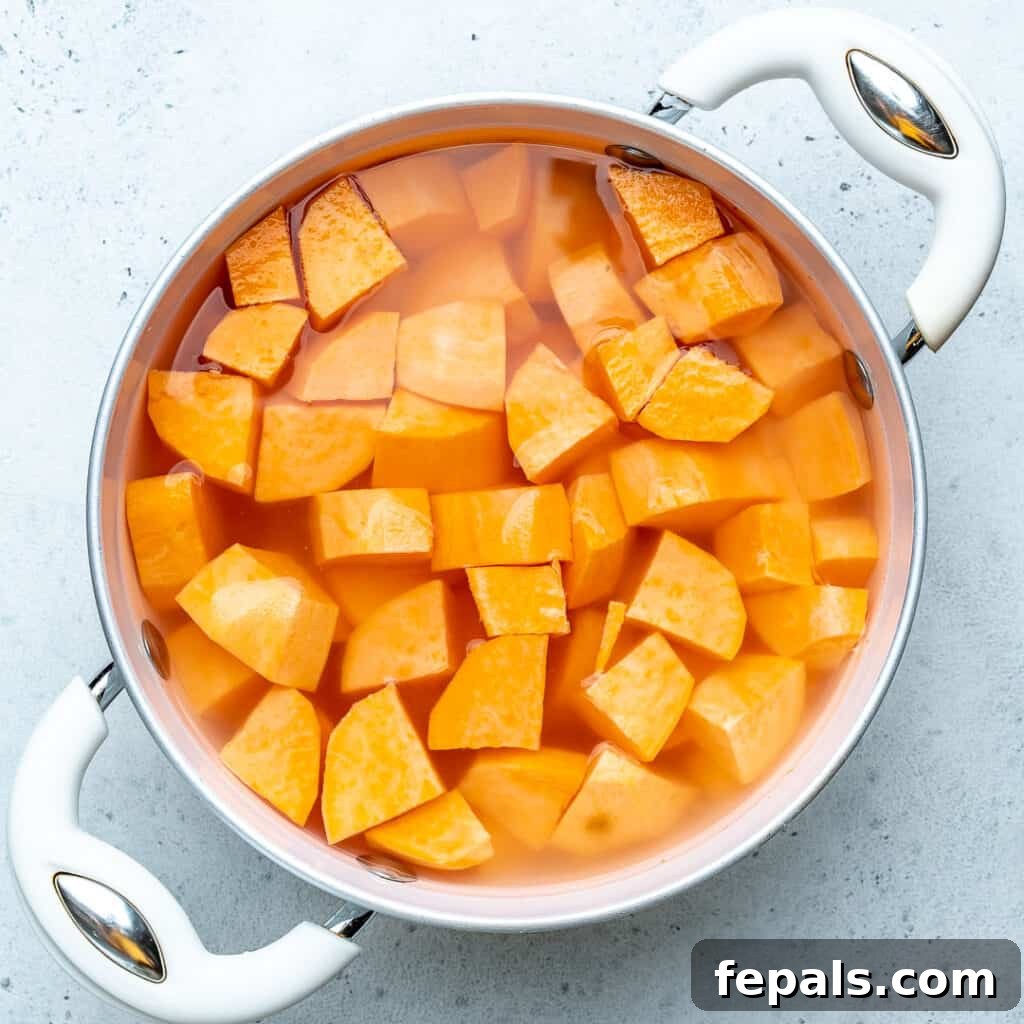 SWEET potato chunks in a pot of water to be boiled