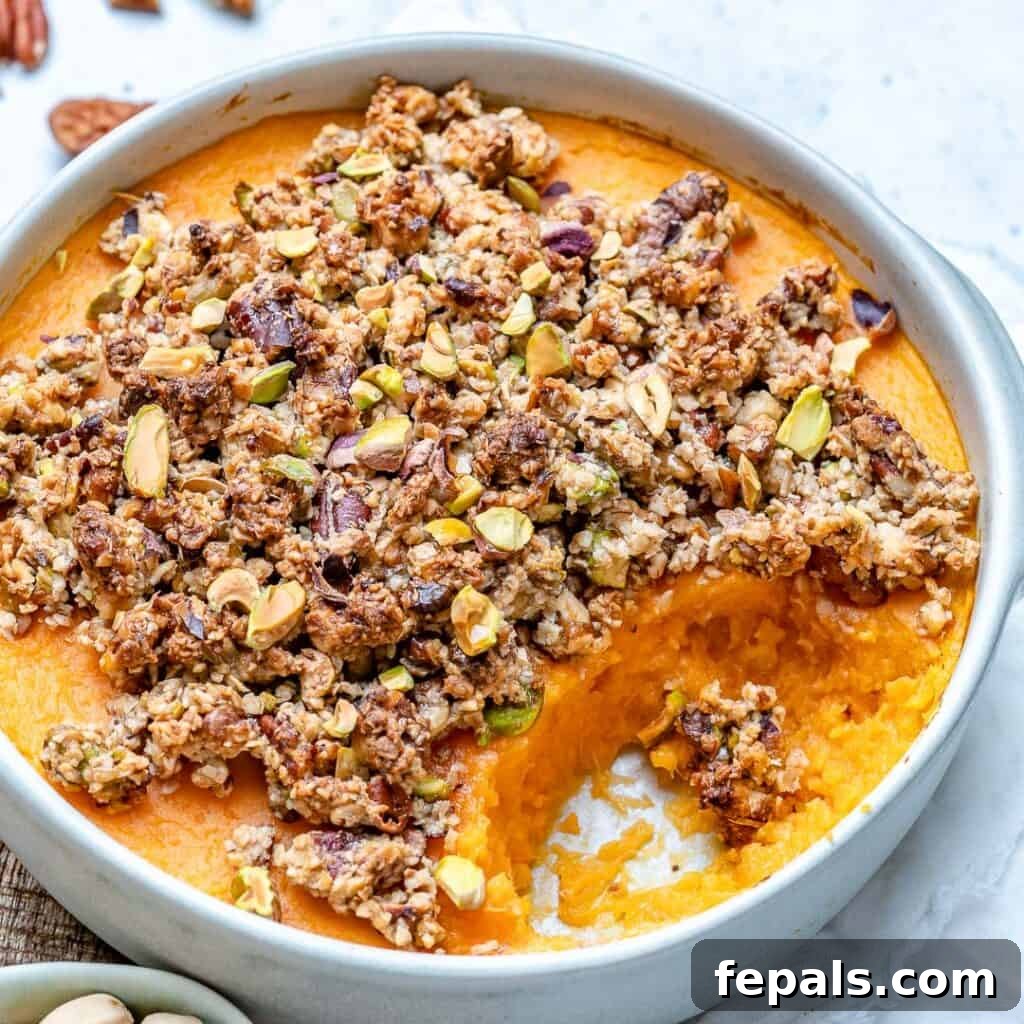 side shot of sweet potato casserole in a dish with a portion taken out