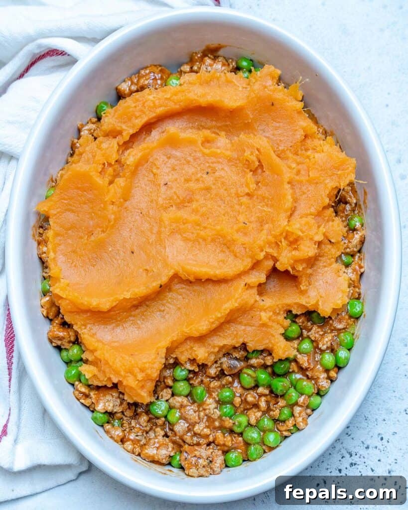 Wholesome Sweet Potato Shepherd's Pie 7 top view of an oval dish with mashed sweet potato over the meat mixture