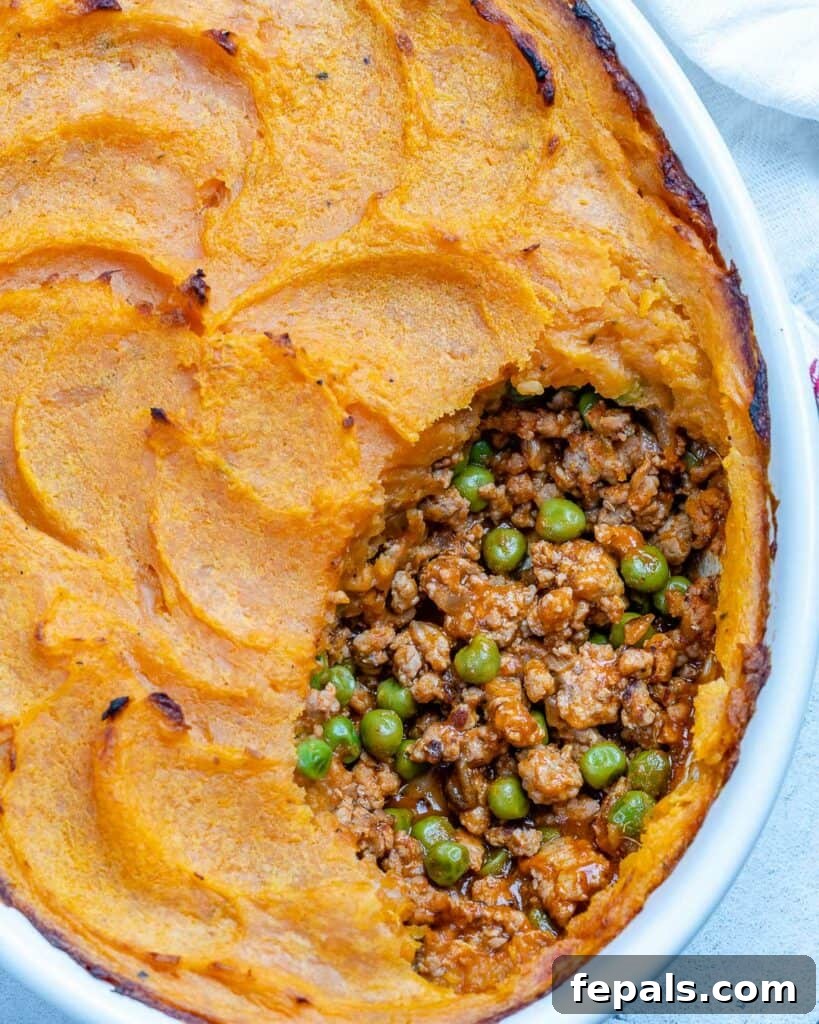 Wholesome Sweet Potato Shepherd's Pie 8 top view up view of a sweet potato shepherd's pie in a dish with a portion taken off