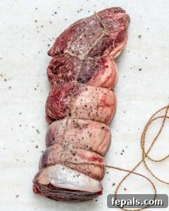 Aromatic Garlic Beef Tenderloin 12 Beef tenderloin tied with rope and seasoned with salt and pepper.