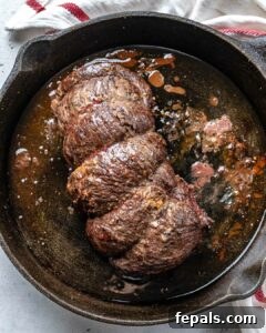 Aromatic Garlic Beef Tenderloin 13 Seared beef tenderloin in a black skillet.