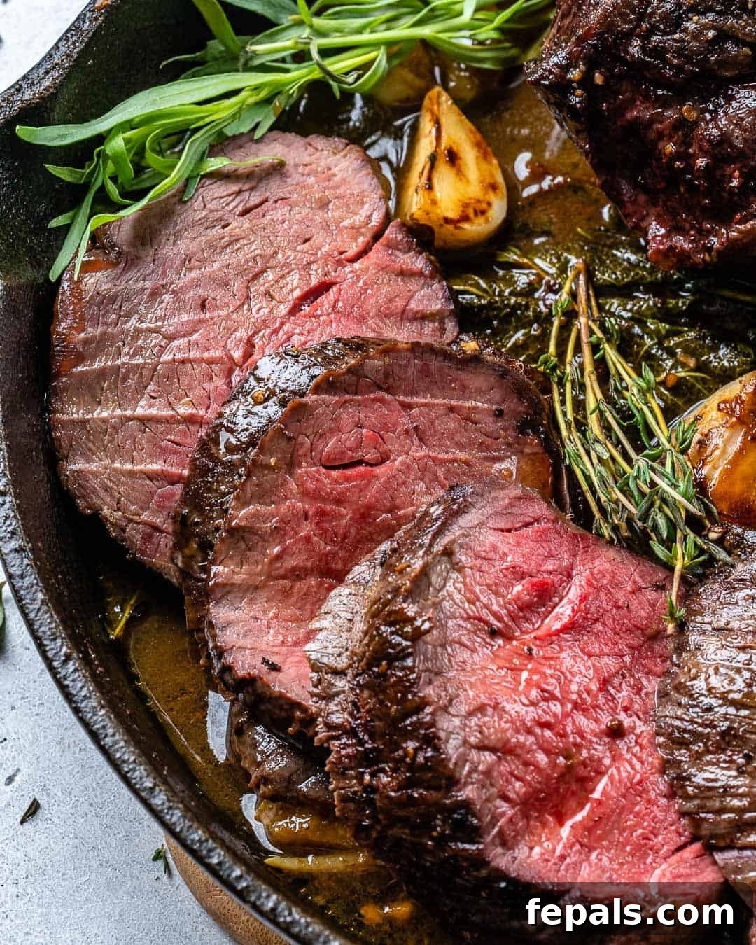 Aromatic Garlic Beef Tenderloin 6 Sliced beef tenderloin on a skillet.