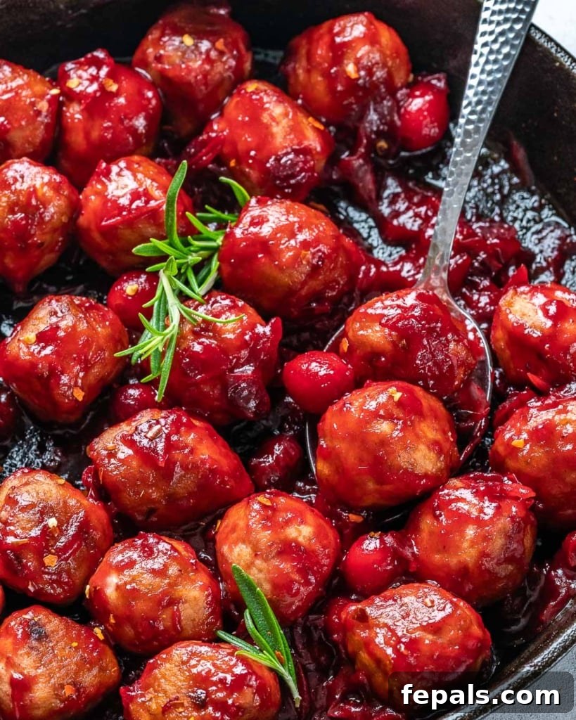 side shot of cranberry sauce chicken meatballs in a skillet