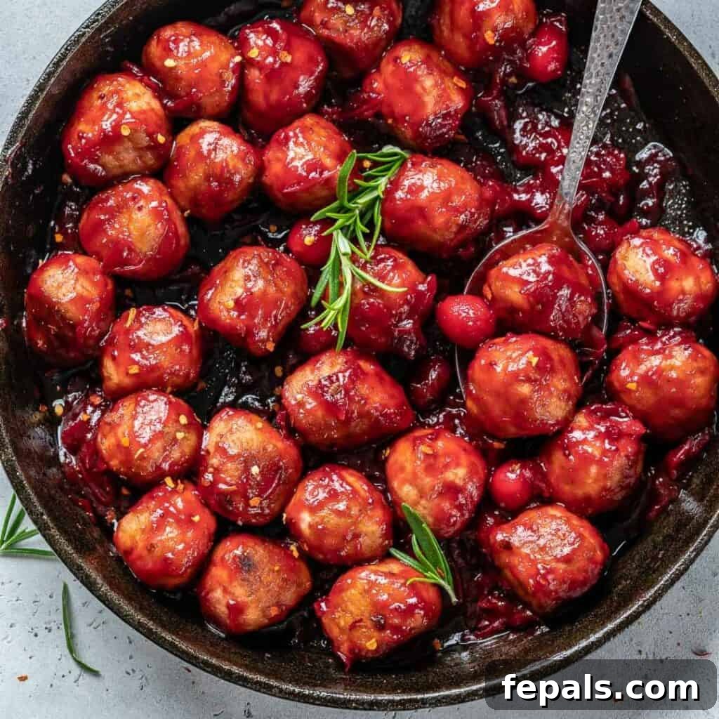 image of some cranberry sauce chicken meatballs in a black skillet