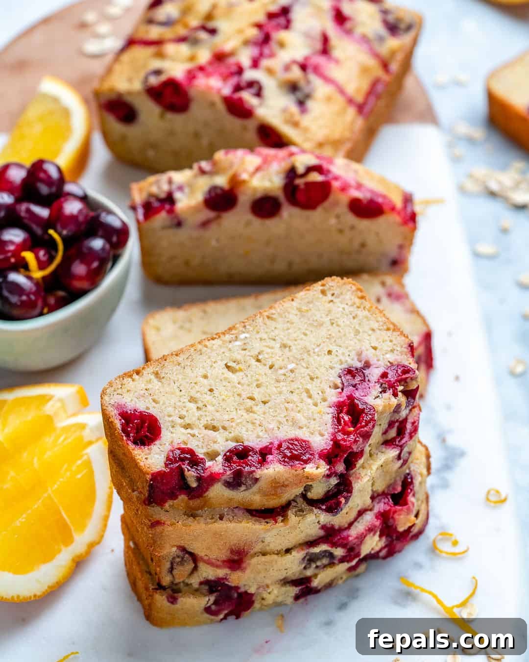 Zesty Cranberry Orange Loaf 3 A stack of golden brown Cranberry Orange Bread slices, showing the moist interior and cranberry pieces