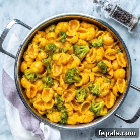 vegan macaroni and cheese with broccoli in a round skillet.