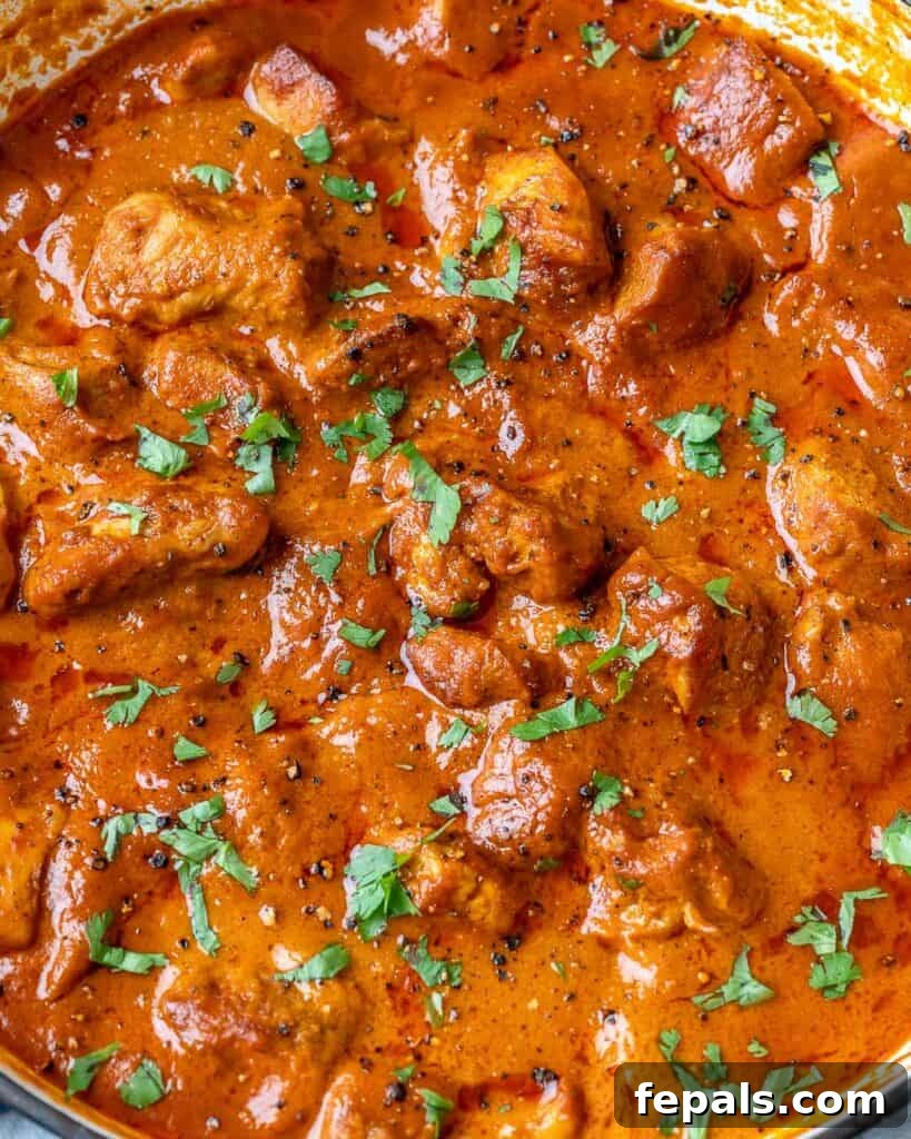 Quick & Creamy Butter Chicken 7 close up image of butter chicken in a pan topped with fresh chopped cilantro