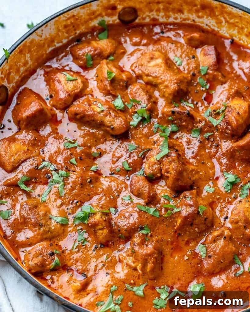 Quick & Creamy Butter Chicken 8 side shot of butter chicken in a pan topped with fresh cilantro