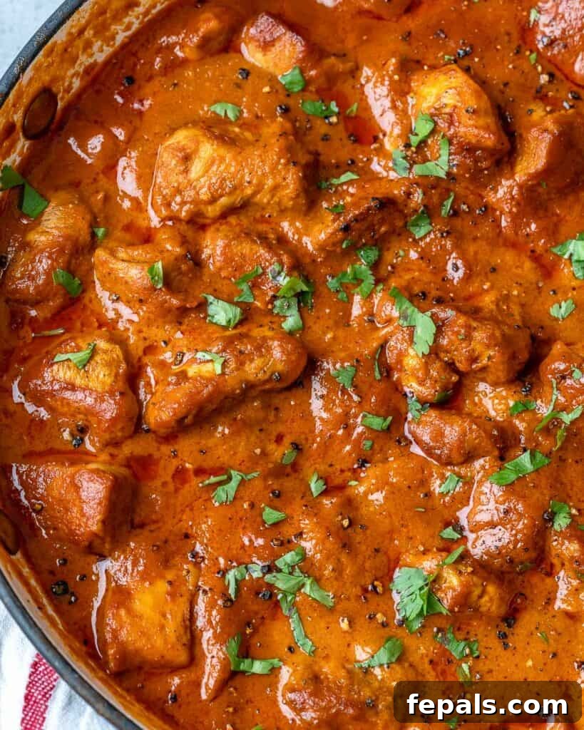 Quick & Creamy Butter Chicken 10 top view of homemade butter chicken in a pan topped with fresh chopped cilantro