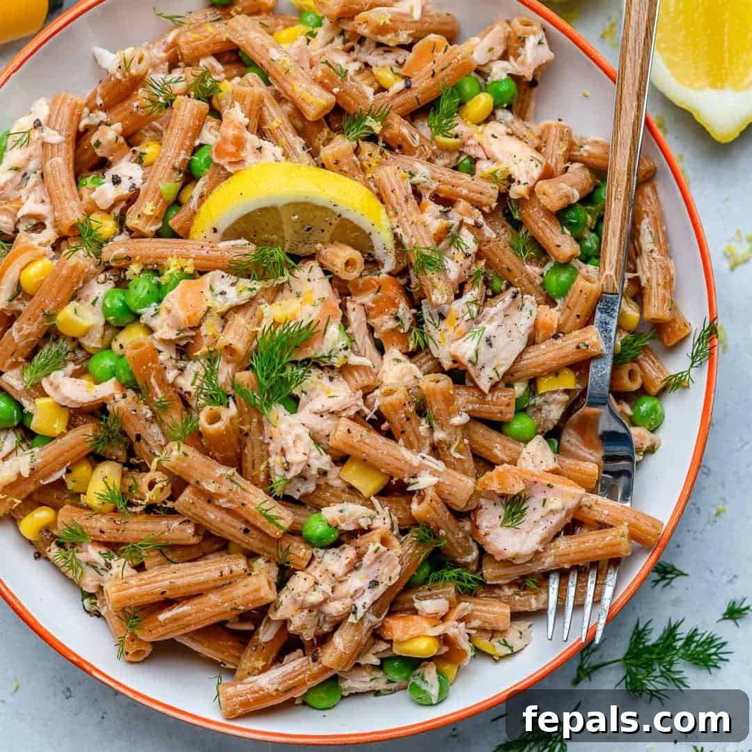Close-up of lemon dill salmon pasta salad in a glass bowl, perfect for meal prep