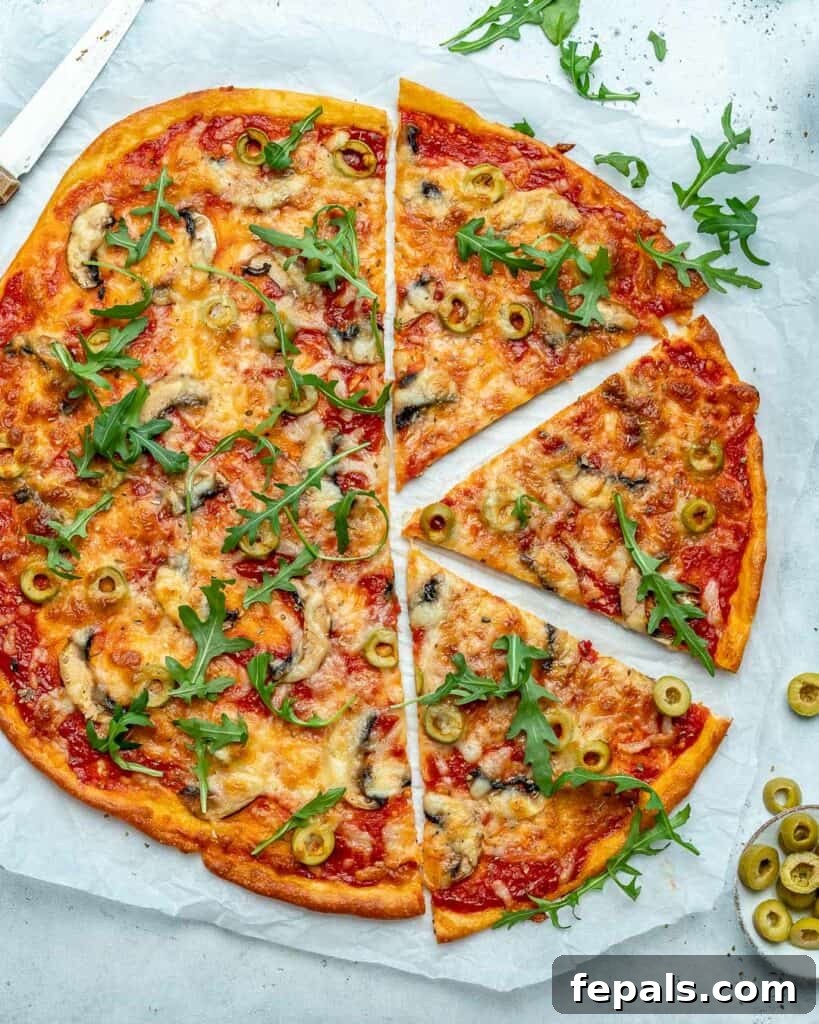 Top view of a whole, beautifully baked thin-crust pizza, with three perfectly cut slices arranged on the right side, ready to be enjoyed.