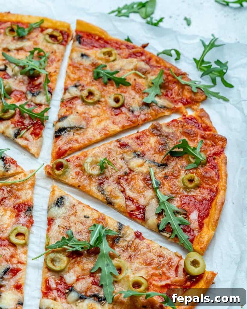 Close-up view of perfectly thin-crust pizza slices arranged on parchment paper, highlighting the crispiness and golden-brown edges.