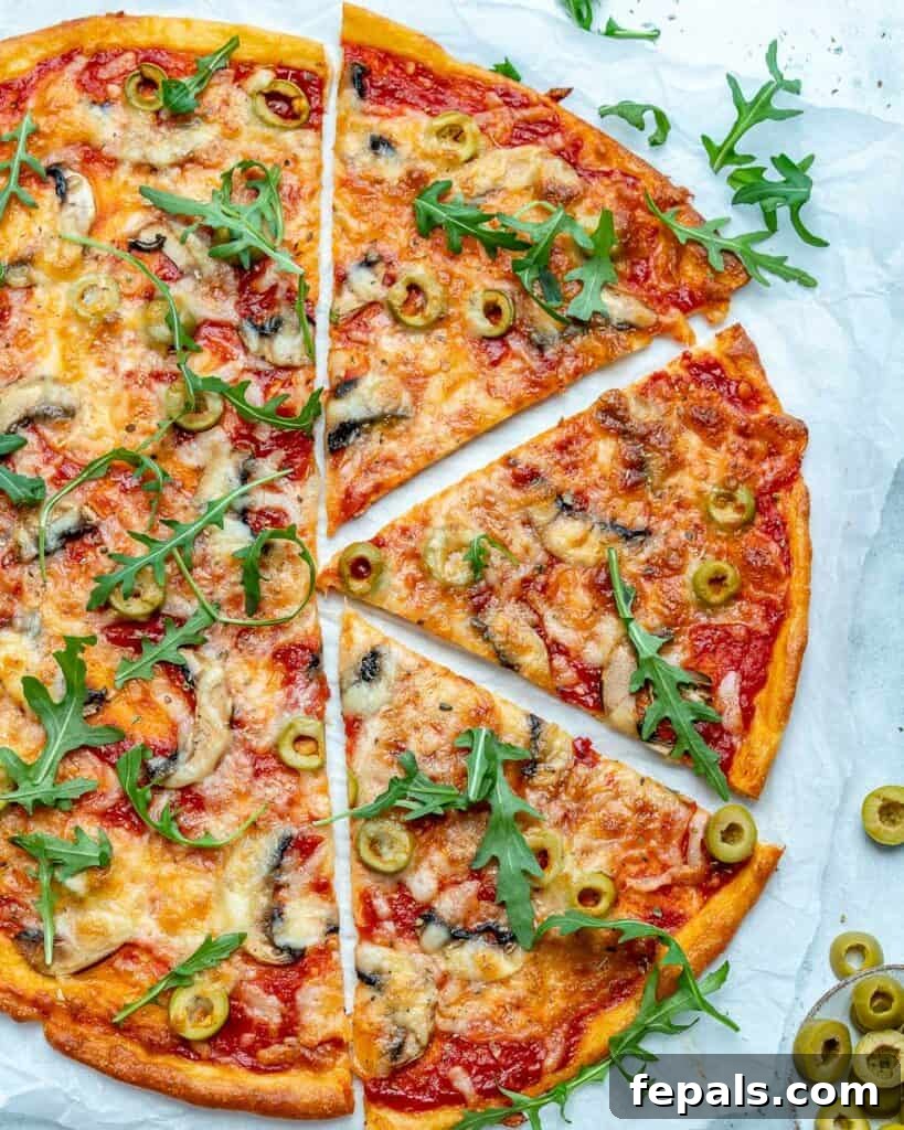 Top view of a whole, perfectly baked thin-crust pizza with the right side divided into three delectable slices.