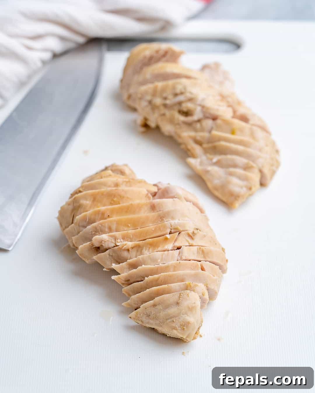 Perfectly Poached Chicken Every Time 7 Poach chicken sliced on cutting board
