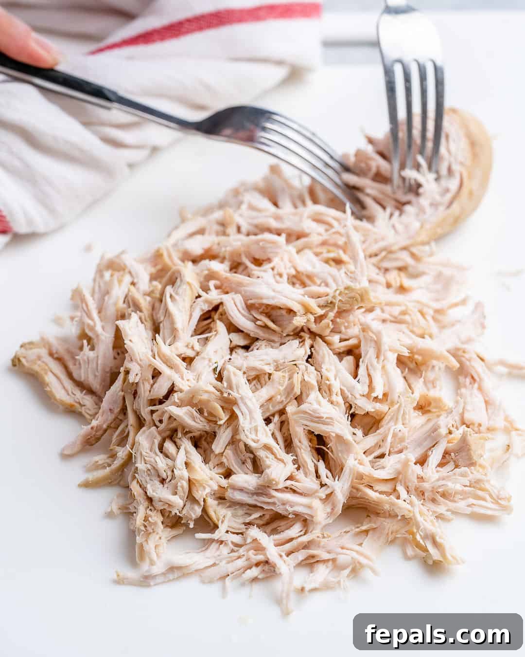 Perfectly Poached Chicken Every Time 8 Poached chicken shredded on cutting board