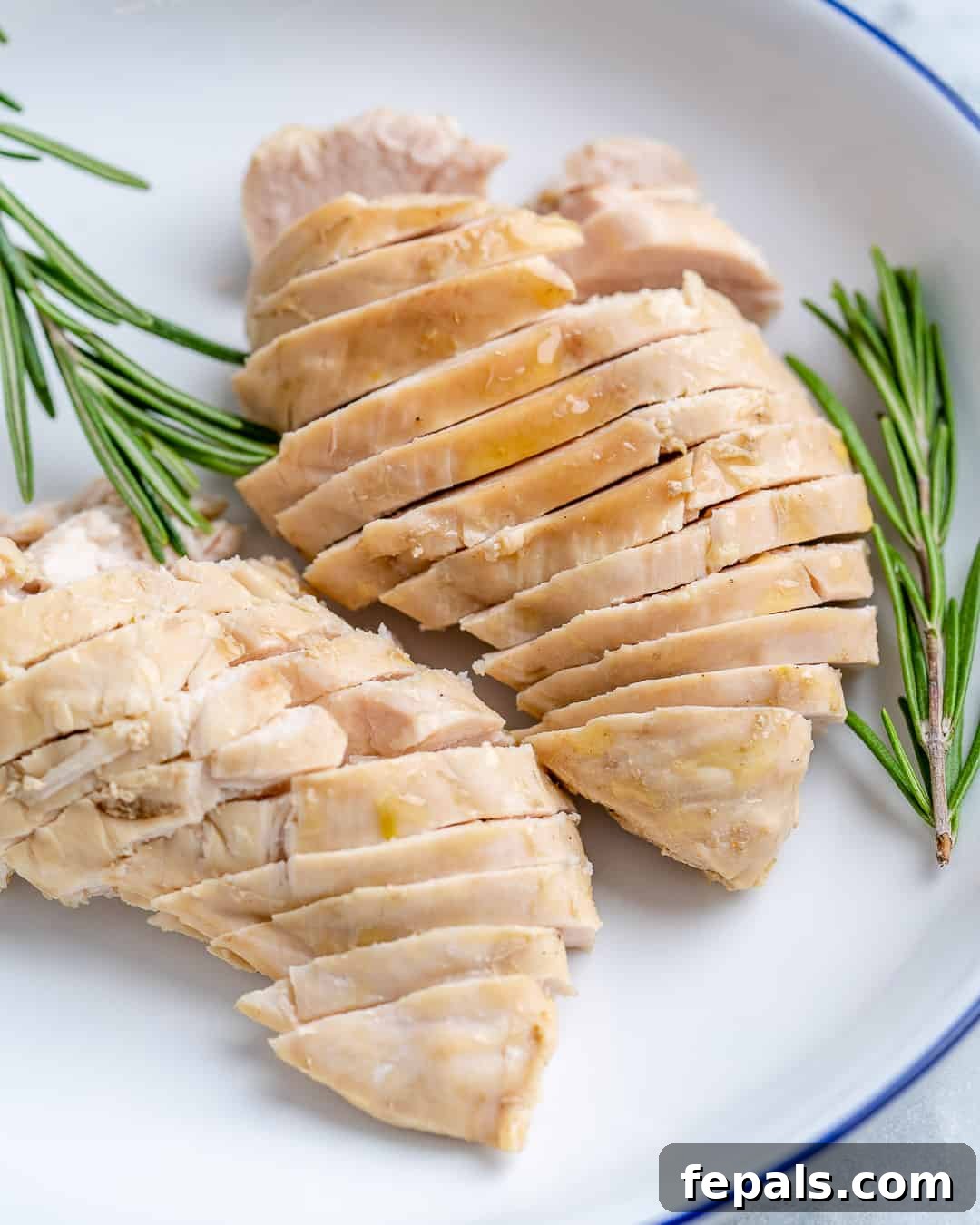 Perfectly Poached Chicken Every Time 9 Sliced poached chicken on plate