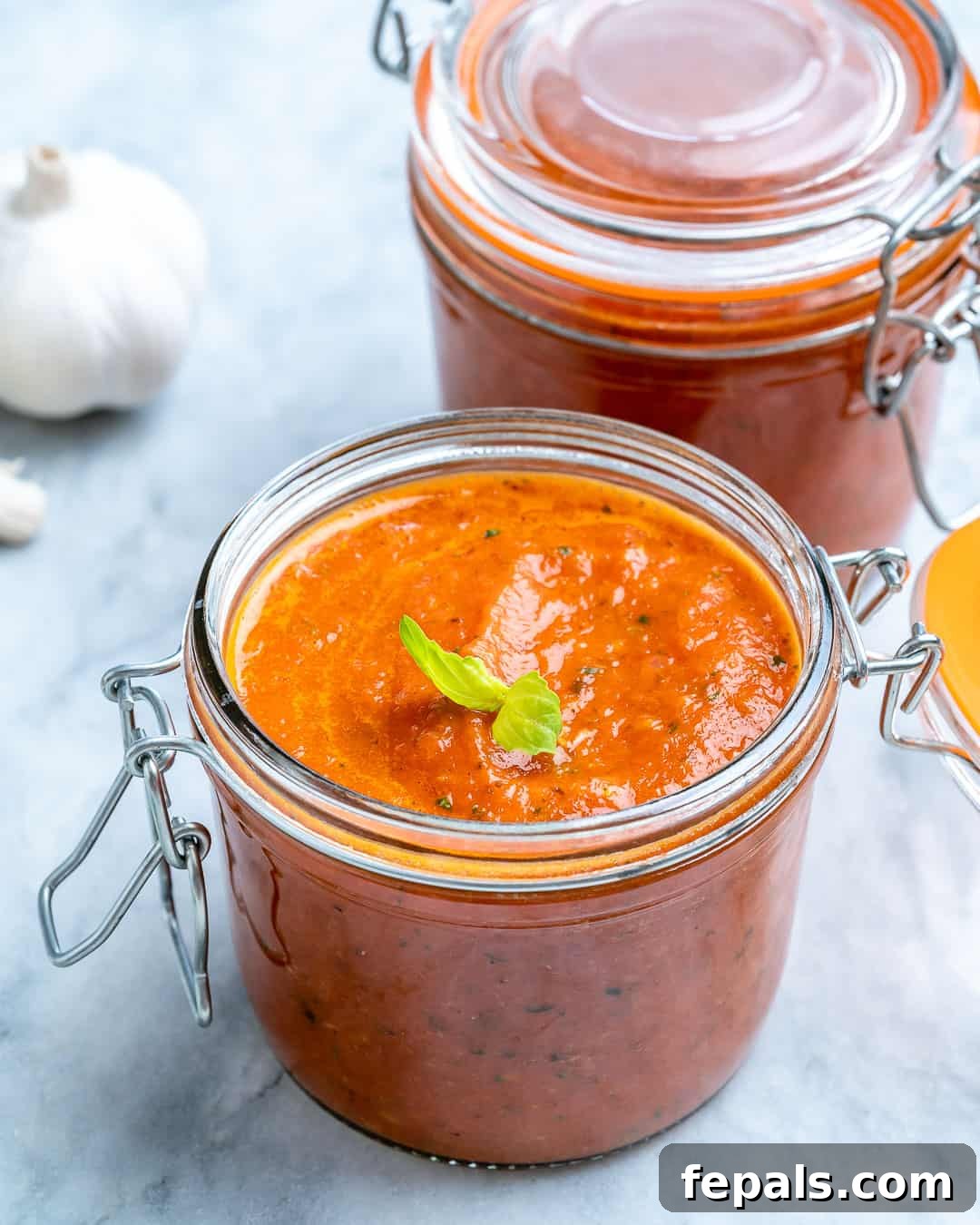Fresh homemade marinara sauce in a glass mason jar, ready for storage or serving.